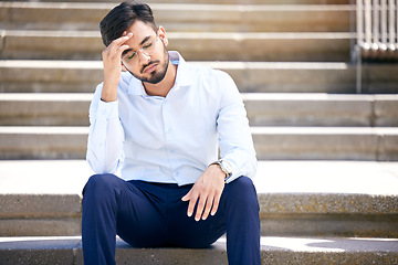 Image showing Business man, stress and outdoor on stairs with a headache, depression or burnout in city. Young Indian male entrepreneur frustrated, anxiety or problem after being fired, unemployed or fail mistake