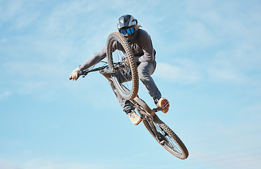 Image showing Extreme sports, bike jump and cyclist cycling a bicycle for competition stunt routine or training speed in mockup space. Skill, contest and athlete workout or practice sky or air trick for fitness