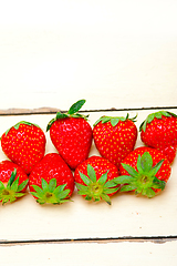 Image showing fresh organic strawberry over white wood