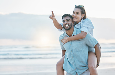 Image showing Couple, piggyback on beach and love, travel and holiday, mockup space and happy together outdoor. Summer, support and care with affection, man and woman pointing in nature with adventure by the ocean