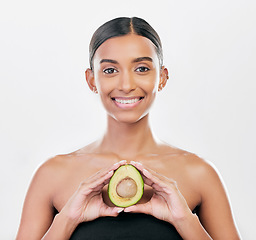 Image showing Woman, beauty and avocado in studio portrait for health, wellness and diet for facial glow by white background. Girl, model and healthy skin with fruit, makeup or cosmetics for self care with smile