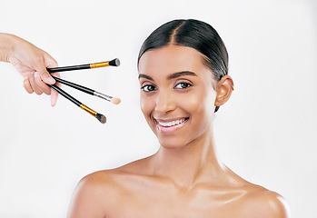 Image showing Portrait, skincare and woman with makeup, brushes and dermatology against a white studio background. Face, female person or model with cosmetics tools, shine or luxury with wellness, facial or health