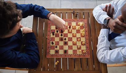 Image showing Chess, board game and business men playing at a table from above while moving piece for strategy. Male friends together to play, relax and bond with icon for problem solving, challenge or checkmate