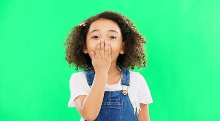 Image showing Wow, surprise and children with a girl on a green screen background standing hand over mouth. Portrait, face and gasp with an adorable little female child hearing gossip or a rumor on chromakey