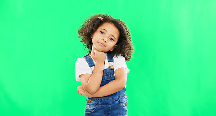 Image showing Cute, face and child in a studio with green screen with a adorable, sweet and happy expression. Happiness, smile and portrait of a young girl kid posing while isolated by a chroma key background.