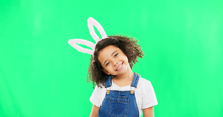 Image showing Cute, happy and face of a child with bunny ears isolated on a green screen studio background. Easter, smile and portrait of an adorable little girl smiling, looking cheerful and playful with mockup