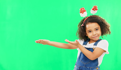 Image showing Product placement, green screen and portrait of a child doing a presentation on a studio background. Branding, mockup and girl kid showing a space for marketing, display or advertising on a backdrop