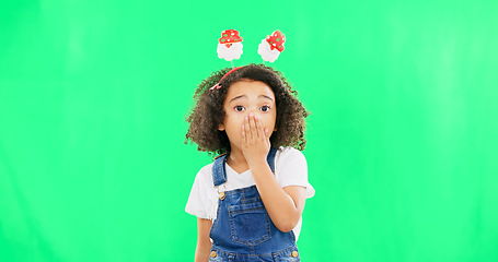 Image showing Shock, face and child in a studio with green screen with a wtf, omg or surprise facial expression. Christmas, festive and portrait of a girl kid with a xmas headband and wow gesture by chroma key.