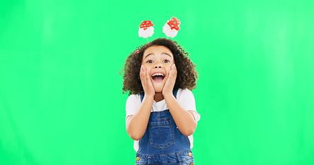 Image showing Excited, happy face and child with green screen and smile and Christmas headband ready for celebration. Comic, surprised and shocked portrait of a young girl with happiness about holiday event