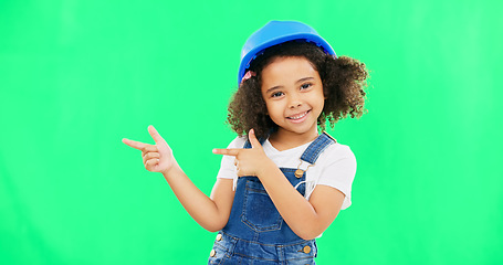 Image showing Kids, construction and a girl on a green screen background in studio pointing at building space. Children, architecture and design with a cute female child engineer wearing a hardhat on chromakey