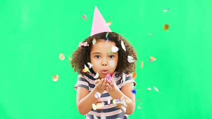 Image showing Little girl, birthday and blowing confetti on green screen for party celebration isolated against a studio background. Portrait of cute kid celebrating event with glitter decor for new year on mockup