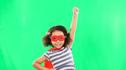 Image showing Child, superhero and hand to fly on green screen to stop crime and fight with fantasy or cosplay costume. Girl power, hero and game with smile of strong kid portrait to protect freedom and justice