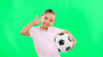 Image showing Girl, soccer ball and thumbs up in green screen studio with smile, face and happiness in sport mockup. Young female child, football mock up and happy for kids sport agreement, portrait and training