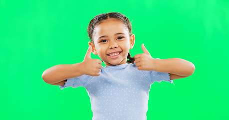 Image showing Thumbs up, happy and child in agreement excited, winning and girl kid isolated in studio green screen background. Yes, approval and portrait of young person with yes hands, gesture or sign