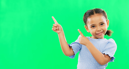 Image showing Happy, pointing and mockup with girl in studio for product placement, promotion and offer. Choice, launch and smile with portrait of child on green background for brand, advertisement and display
