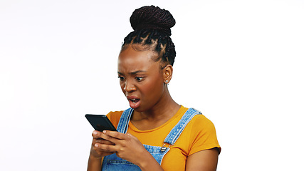 Image showing Phone, bad news and anger with a black woman in studio isolated on a white background reading a negative text message. Mobile, communication and upset with an annoyed female browsing social media