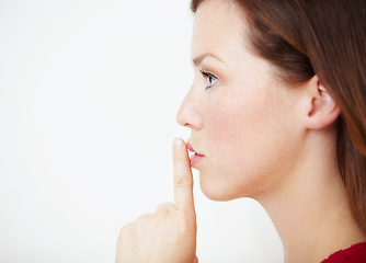 Image showing Mockup, secret and woman with finger on lips in studio for gossip, drama or silent gesture on white background. Whisper, news and female with privacy, confidential or did you know, blackmail or emoji