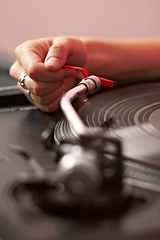 Image showing Closeup, dj hand and vintage turntable with vinyl, music system and needle for sound job, party or audio gear. Person, retro record player and disc for scratch, spinning and listening in club in zoom