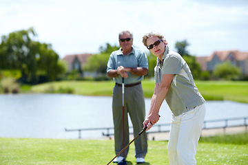 Image showing Mature, woman or portrait of golfer on golf course for fitness, workout or stroke exercise in retirement. Senior couple, sunglasses or serious lady training in golfing sports game driving with a club