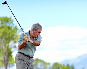 Image showing Swing, old man or golfer playing golf for fitness, workout or stroke exercise on a course in retirement. Mature, golfing or senior player training in sports game driving with club or driver outdoors