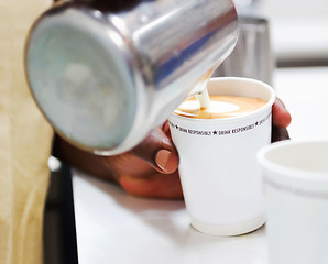 Image showing Coffee, milk and hands of barista in cafe for cappuccino, breakfast or hot caffeine beverage. Closeup, waiter or pouring dairy foam for takeaway drink, latte art or premium cup of mocha in restaurant