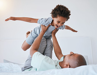 Image showing Airplane, playful and father with son in bedroom for morning, wake up and weekend. Happy, excited and funny with man and young child playing in family home for happiness, freedom and support