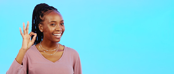 Image showing Perfect, sign and woman with okay hand gesture smile and happy with mockup space isolated in a studio blue background. Portrait, satisfaction and African American woman with support and winning emoji