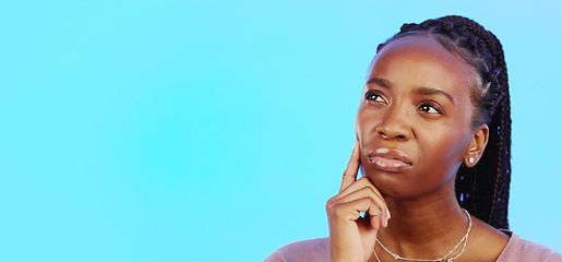 Image showing Thinking, idea and black woman in doubt with mockup and confusion isolated on blue background. Ideas, concentration and difficult choice for African in studio space with thoughtful expression on face