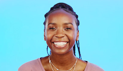 Image showing Face, laughter and smile of a black woman in studio isolated on a blue background for fun or humor. Portrait, happy and laughing with an attractive young female enjoying a joke, comic or funny comedy