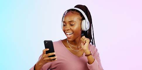 Image showing Dance, music and headphones with black woman and phone in studio for freedom, streaming and online radio. Happiness, technology and relax with girl dancing to track, songs and audio on background