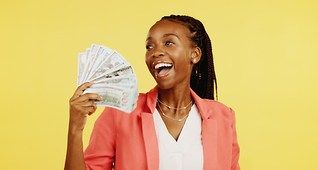 Image showing Cash, fan and winner with a black woman in studio on a yellow background holding money, finance or wealth. Financial, investment and trading with dollar bills in the hand of a female after winning