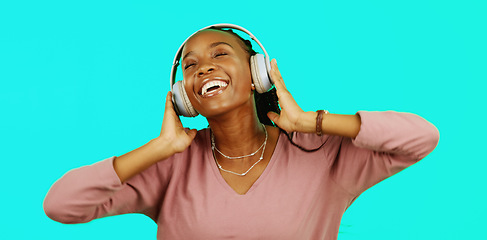 Image showing Dance, music and headphones with black woman in studio for freedom, streaming and online radio. Happiness, technology and relax with girl dancing to track, songs and audio isolated on background