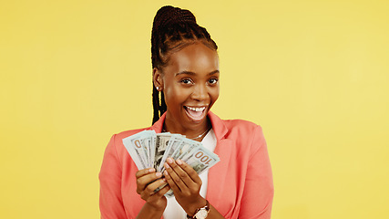 Image showing Finance, fan and winner with a black woman in studio on a yellow background holding cash, money or wealth. Financial, investment and trading with dollar bills in the hand of a female after winning