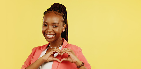 Image showing Heart hands, happy and love with black woman in studio for icon, confident and kindness. Gratitude, smile and emoji with girl and positive gesture for support, care and sign isolated on background