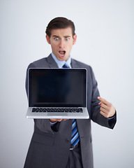 Image showing Laptop screen, mockup and shocked with business man in studio for website, email and pointing. Wow, surprised and technology with employee in white background for corporate, internet and networking