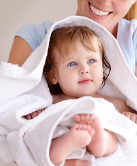 Image showing Mom, hug and baby with bath for care or clean kid in a closeup at home with love for family life. Infant, towel and mother to hold with caring in arm for bond or cleaning or wellness of child.