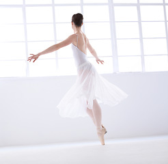 Image showing Dance, ballet and theatre with woman in studio for balance, elegant and performance. Artist, creative and training with female ballerina dancing in class for competition, freedom and commitment
