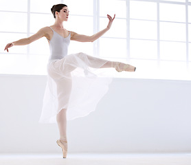 Image showing Dance, ballet and moving with woman in studio for balance, elegant and performance. Artist, theatre and training with female ballerina dancing in class for competition, freedom and commitment