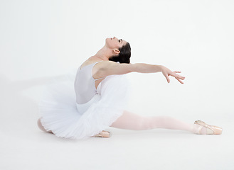 Image showing Theatre, dance and ballet with a woman in studio on a white background for rehearsal or recital for a dancing performance. Art, creative and expression with a young ballerina or dancer in uniform