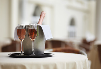 Image showing Restaurant, bottle and glasses of champagne on a table for luxury service, celebration and hospitality. Hotel, wealth and wine, alcohol and drinks at a fine dining establishment for an experience