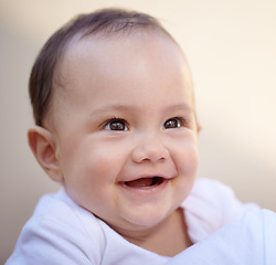 Image showing Happy, closeup face of a baby with a smile and health wellness for childhood development. Happiness or excited, childhood or giggle for fun and toddler smiling for healthcare with laugh for comedy