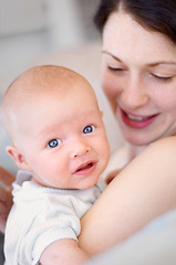 Image showing Happy, care and portrait of a mother with a baby for bonding, love and happiness. Smile, caring and a mom holding and embracing a newborn child for childcare, motherhood and parenting in a house