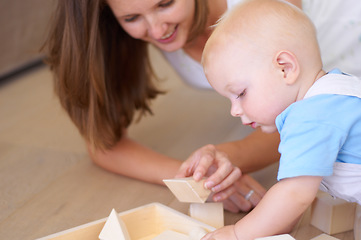 Image showing Baby, mother with toy or wood building blocks for child development, help learning or knowledge. Mom, boy and teaching toddler to play with toys, learn and grow on floor of living room in home