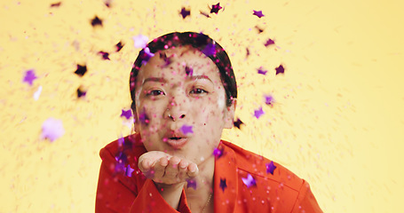 Image showing Studio, asian woman blowing confetti and celebration for birthday, anniversary or celebrating Chinese new year. Happy party, smile and model from china on yellow background to celebrate with glitter