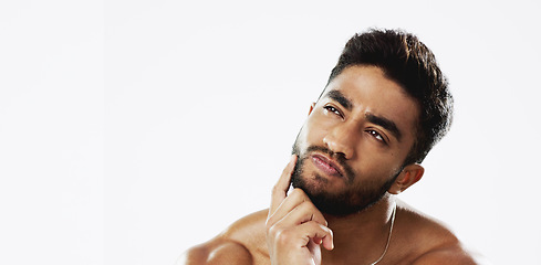 Image showing Confused, thinking and face of man in studio for wellness, skincare and hygiene on white background. Doubt, portrait and indian male model with unsure emoji contemplating beauty cosmetic or body care