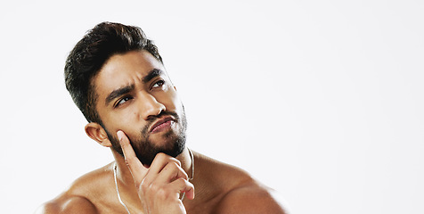 Image showing Thinking, confused and face of man in studio for wellness, skincare and hygiene on white background. Doubt, portrait and indian male model with unsure emoji contemplating beauty cosmetic or body care