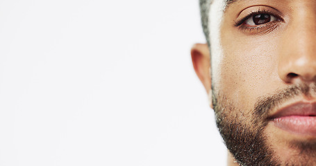 Image showing Face, closeup and man in studio for skincare, against white background. Zoom and serious man portrait of Indian male model excited for wellness, beauty and cosmetic care while isolated