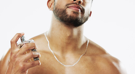 Image showing Beauty, cosmetics and man with cologne, fragrance and wellness against a grey studio background. Latino guy, male and perfume for aroma, fresh scent and confidence with spray, self care and hygiene