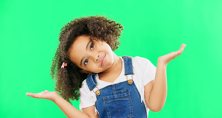 Image showing Kids, doubt and a confused girl shrugging her shoulders on a green screen background in studio. Children, portrait and question with an adorable little female child asking on chromakey mockup