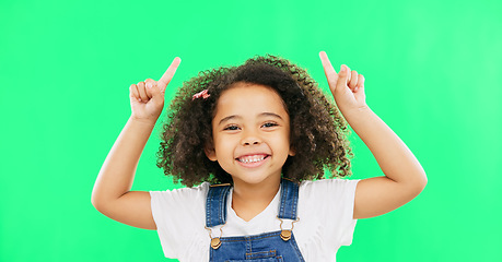 Image showing Mockup, green screen and child pointing up at product placement space isolated against a studio background. Excited, happy and portrait of young kid advertising and marketing showing deal or sale